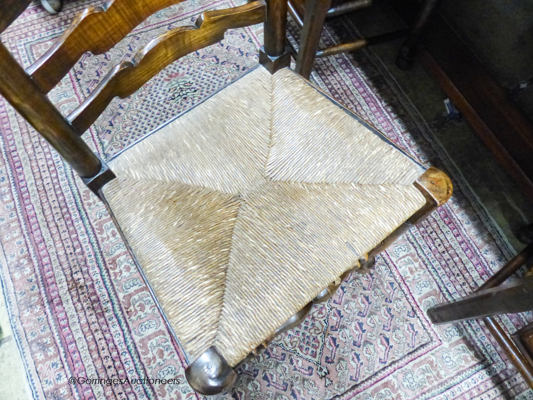 A set of four 18th century style ash rush seat ladderback dining chairs